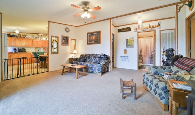 living area featuring light carpet, ceiling fan, and ornamental molding