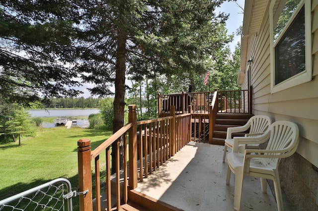 deck featuring a yard and stairs