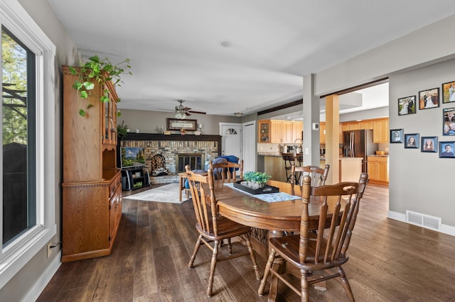27088 130th St, Thomastown Twp, MN 56479 - dining space with ceiling fan, a fireplace, dark wood-style floors, and baseboards