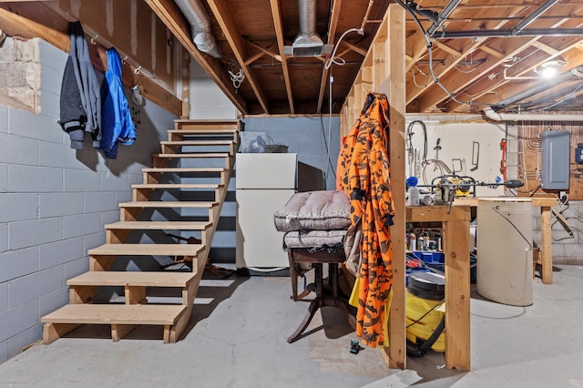 27088 130th St, Thomastown Twp, MN 56479 - unfinished basement featuring electric panel, freestanding refrigerator, stairs, and concrete block wall