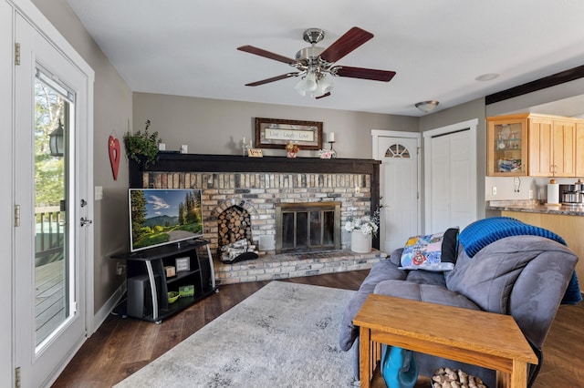 27088 130th St, Thomastown Twp, MN 56479 - living area featuring dark wood finished floors, ceiling fan, a fireplace, and baseboards