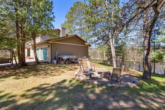 27088 130th St, Thomastown Twp, MN 56479 - view of green lawn with an outdoor fire pit