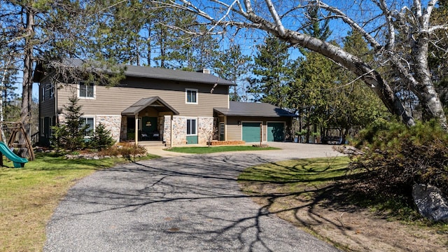 27088 130th St, Thomastown Twp, MN 56479 - view of front of house featuring asphalt driveway, a garage, stone siding, a chimney, and a front yard