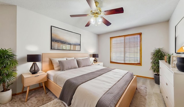 bedroom with baseboards, light carpet, and ceiling fan