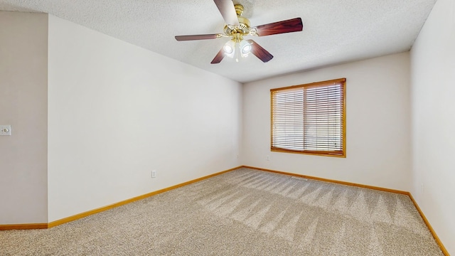 empty room with light colored carpet, baseboards, a textured ceiling, and ceiling fan