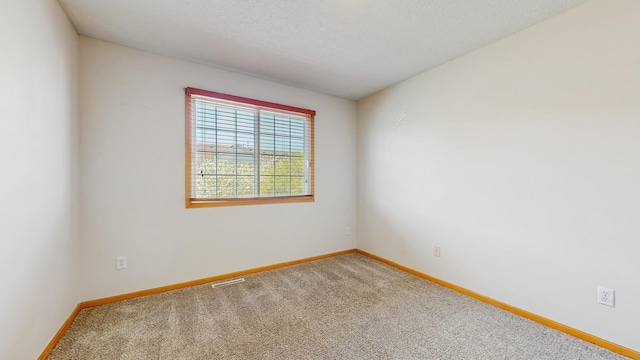 empty room with carpet floors and baseboards