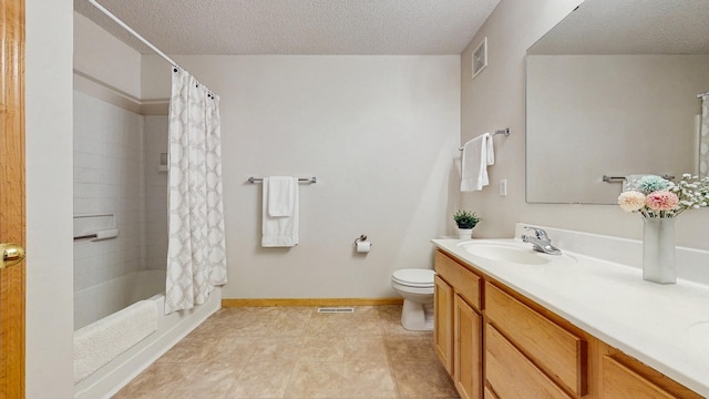 bathroom with a textured ceiling, toilet, vanity, shower / tub combo with curtain, and baseboards