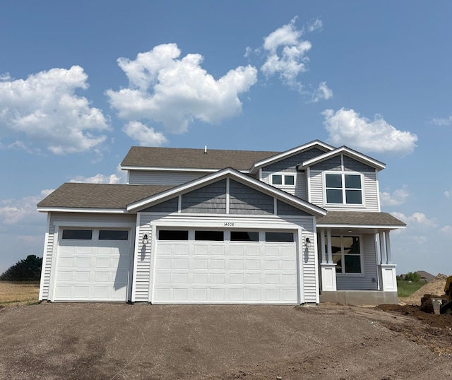 14608 74th St NE, Otsego, MN 55330 - view of front facade featuring driveway, an attached garage, and a shingled roof