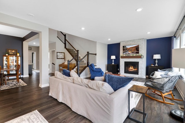 13404 Avila Ave, Rosemount, MN 55068 - living room featuring stairs, dark wood-style flooring, a stone fireplace, baseboards, and recessed lighting