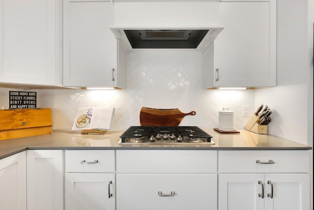 13404 Avila Ave, Rosemount, MN 55068 - kitchen featuring white cabinets, decorative backsplash, stainless steel gas cooktop, and exhaust hood