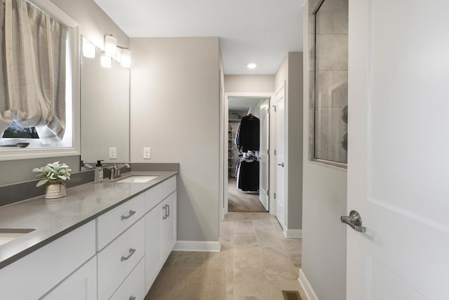 13404 Avila Ave, Rosemount, MN 55068 - full bath featuring double vanity, a tile shower, a spacious closet, baseboards, and recessed lighting