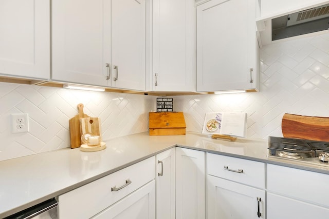 13404 Avila Ave, Rosemount, MN 55068 - kitchen with extractor fan, white cabinetry, backsplash, and light countertops