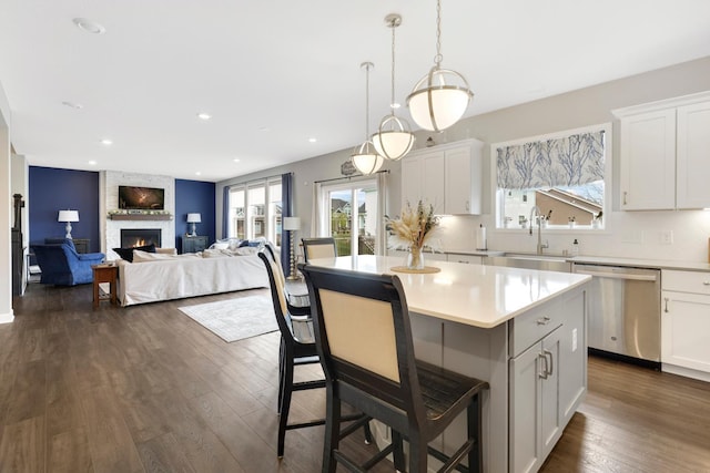 13404 Avila Ave, Rosemount, MN 55068 - kitchen featuring dishwasher, healthy amount of natural light, a fireplace, a kitchen island, and recessed lighting