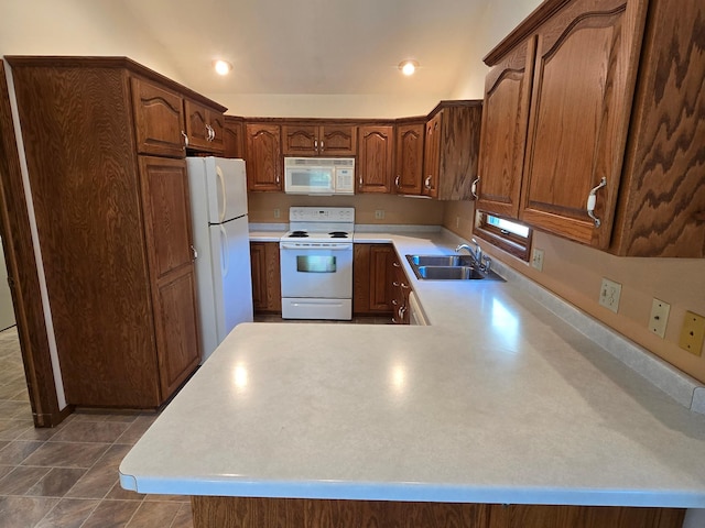 735 10th Ave S, Waite Park, MN 56387 - kitchen with white appliances, a sink, light countertops, a peninsula, and dark tile patterned flooring