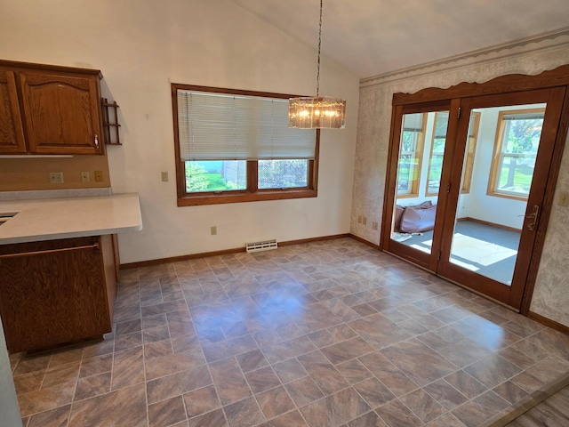 735 10th Ave S, Waite Park, MN 56387 - unfurnished dining area featuring plenty of natural light, a chandelier, baseboards, and lofted ceiling