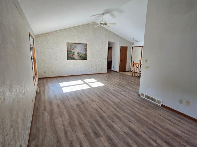735 10th Ave S, Waite Park, MN 56387 - unfurnished living room with a ceiling fan, wood finished floors, vaulted ceiling, and baseboards