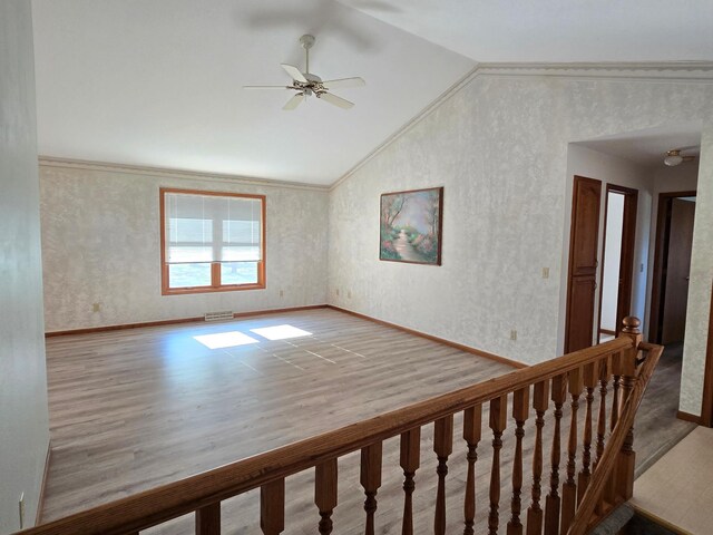 735 10th Ave S, Waite Park, MN 56387 - unfurnished room with lofted ceiling, a ceiling fan, wood finished floors, baseboards, and ornamental molding