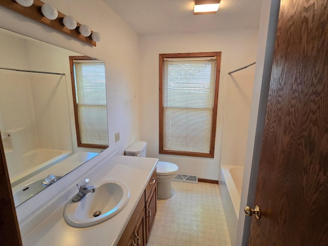 735 10th Ave S, Waite Park, MN 56387 - bathroom featuring tile patterned floors, vanity, healthy amount of natural light, and toilet