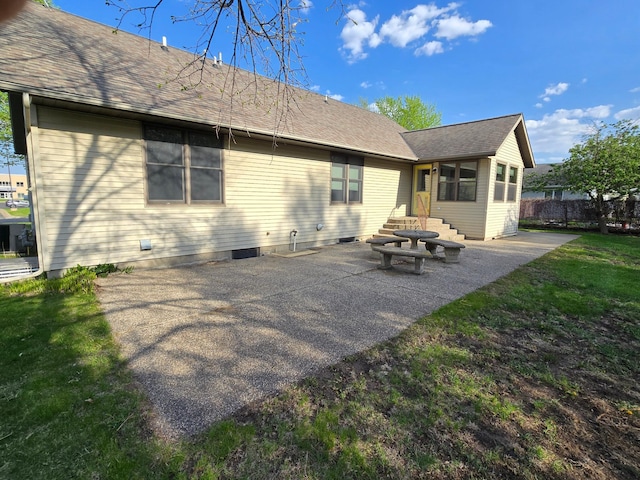 735 10th Ave S, Waite Park, MN 56387 - back of property featuring a patio, a yard, and a shingled roof