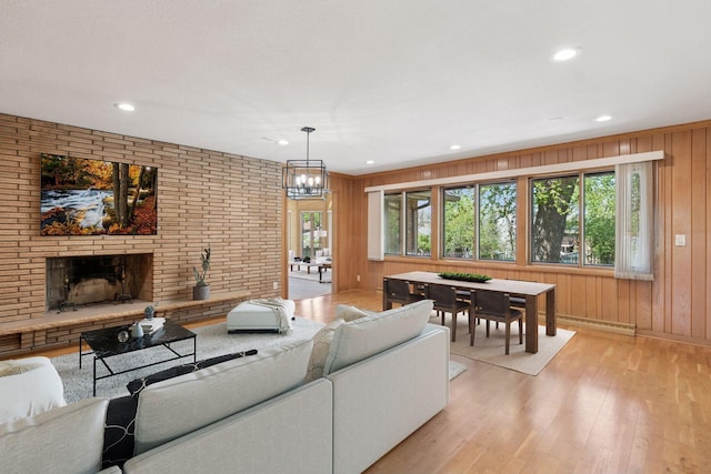 5212 Colonial Dr, Golden Valley, MN 55416 - living area featuring light wood-style flooring, recessed lighting, wood walls, a brick fireplace, and baseboard heating