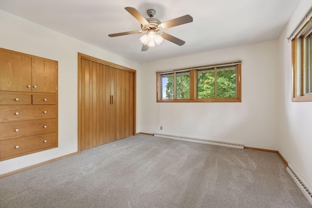 5212 Colonial Dr, Golden Valley, MN 55416 - unfurnished bedroom with a baseboard heating unit, light carpet, and baseboards