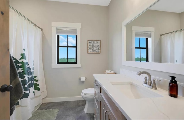 bathroom with baseboards, toilet, vanity, and curtained shower