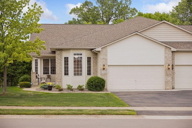 17462 Haralson Dr, Eden Prairie, MN 55347 - view of front facade featuring a shingled roof, brick siding, a front lawn, and asphalt driveway