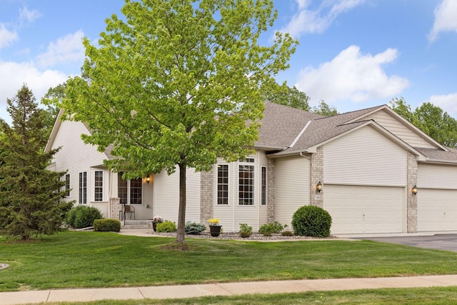 17462 Haralson Dr, Eden Prairie, MN 55347 - obstructed view of property with an attached garage, driveway, a shingled roof, a front yard, and brick siding