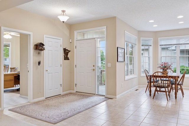 17462 Haralson Dr, Eden Prairie, MN 55347 - foyer featuring healthy amount of natural light, recessed lighting, a textured ceiling, light tile patterned floors, and a ceiling fan