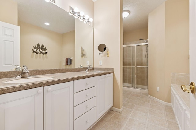 17462 Haralson Dr, Eden Prairie, MN 55347 - full bathroom featuring double vanity, a shower stall, a garden tub, tile patterned floors, and a textured ceiling