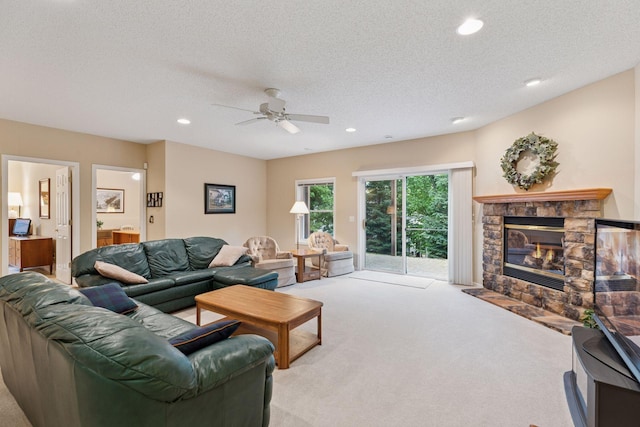 17462 Haralson Dr, Eden Prairie, MN 55347 - carpeted living room with a stone fireplace, recessed lighting, ceiling fan, and a textured ceiling