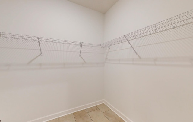 spacious closet with light tile patterned flooring