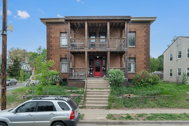 822 35th St, Minneapolis, MN 55408 - multi unit property featuring a balcony, a porch, and brick siding