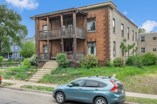 822 35th St, Minneapolis, MN 55408 - multi unit property with brick siding, a balcony, and a porch