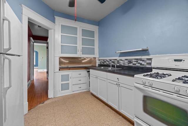 822 35th St, Minneapolis, MN 55408 - kitchen with white appliances, a sink, decorative backsplash, and dark countertops