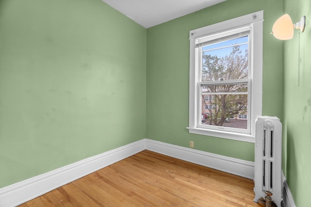 822 35th St, Minneapolis, MN 55408 - spare room with radiator, baseboards, and light wood-type flooring