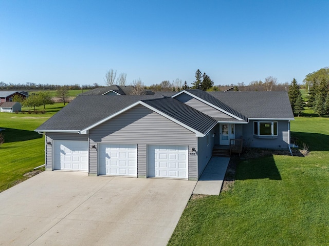 view of front of property featuring a garage, a front lawn, concrete driveway, and a shingled roof