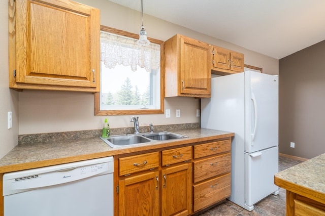 kitchen with white appliances, a sink, hanging light fixtures, and brown cabinetry