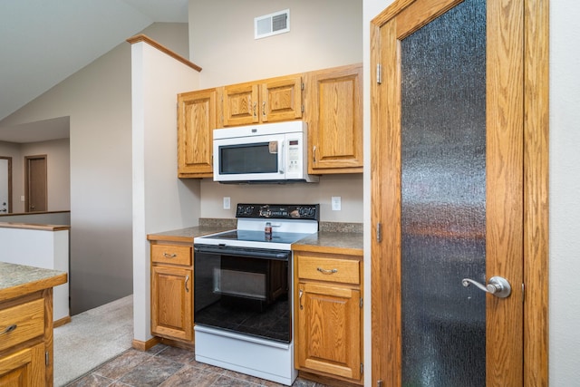 kitchen with white microwave, range with electric stovetop, and lofted ceiling