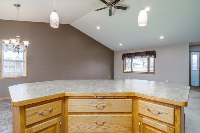 kitchen with a ceiling fan, light countertops, a chandelier, plenty of natural light, and vaulted ceiling