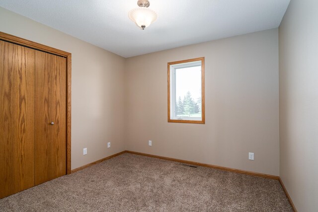 606 5th Ave S, Crookston, MN 56716 - carpeted spare room featuring baseboards