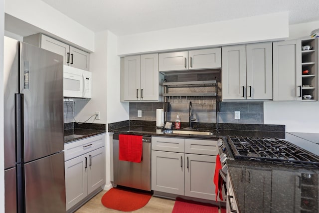 5624 Brookdale Dr N, Brooklyn Park, MN 55443 - kitchen featuring stainless steel appliances, a sink, gray cabinetry, and tasteful backsplash