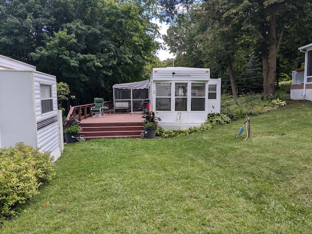 2221 Reubens Ln SW Unit 46, Farwell, MN 56327 - view of green lawn featuring a sunroom and a deck