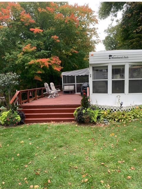 2221 Reubens Ln SW Unit 46, Farwell, MN 56327 - rear view of property featuring a deck and a yard