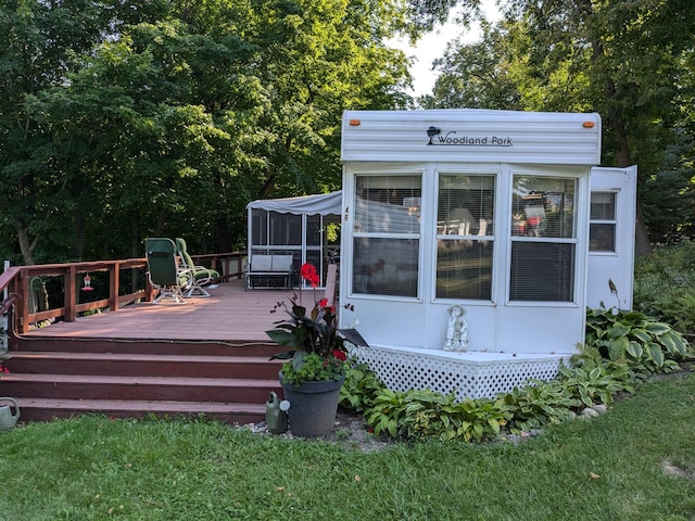 2221 Reubens Ln SW Unit 46, Farwell, MN 56327 - wooden deck featuring a sunroom