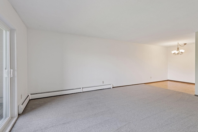 450 Ford Rd Unit 231, Saint Louis Park, MN 55426 - unfurnished room featuring carpet flooring, a chandelier, and a baseboard heating unit