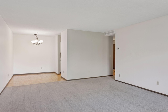 450 Ford Rd Unit 231, Saint Louis Park, MN 55426 - spare room featuring a chandelier, carpet floors, and baseboards