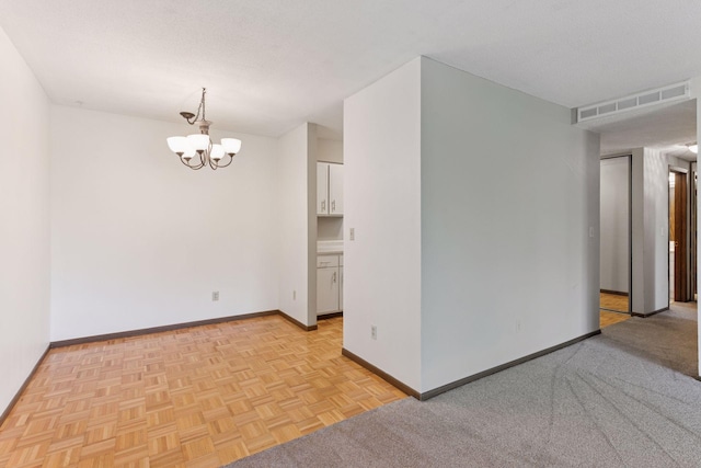 450 Ford Rd Unit 231, Saint Louis Park, MN 55426 - spare room featuring baseboards and a chandelier