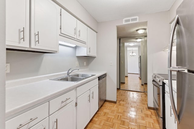450 Ford Rd Unit 231, Saint Louis Park, MN 55426 - kitchen featuring stainless steel appliances, a sink, white cabinetry, light countertops, and a textured ceiling
