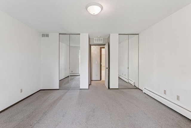 450 Ford Rd Unit 231, Saint Louis Park, MN 55426 - unfurnished bedroom featuring a baseboard heating unit, two closets, and baseboards